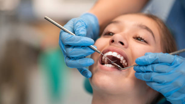 istock Little girl having a dental exam 1383424874