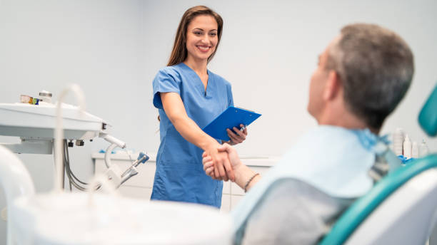 istock Mid adult man having teeth examined at dentists 1383424883
