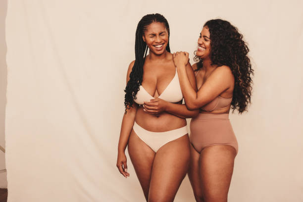 istock Women laughing together while wearing underwear in a studio 1383424908