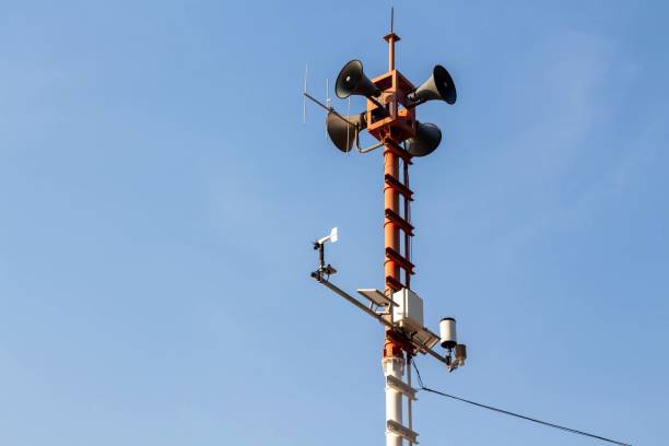 istock Tsunami warning pole located on the beach with a blue sky background. 1383427042