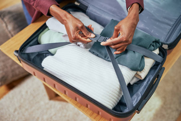 istock Unrecognizable afro person packing suitcase 1383427070
