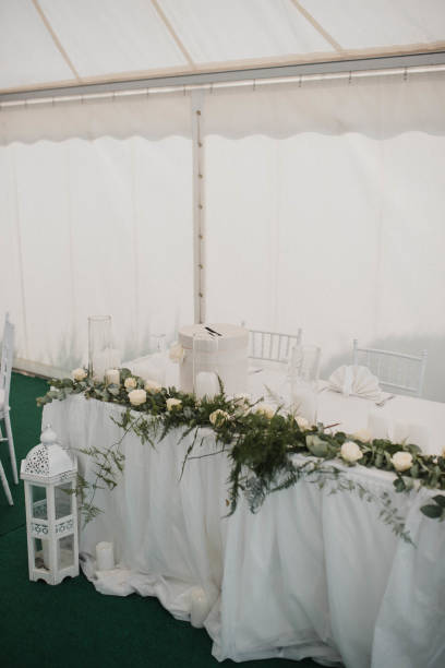 istock Table setting at a luxury event and beautiful flowers on the table. Beautiful wedding arch of flowers 1383430140