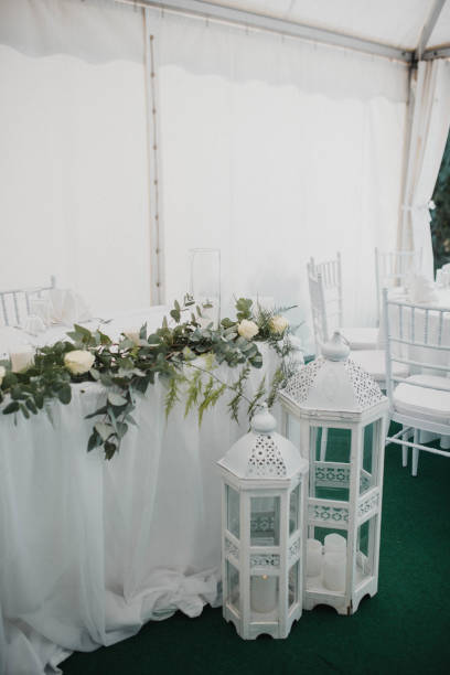 istock Table setting at a luxury event and beautiful flowers on the table. Beautiful wedding arch of flowers 1383430413