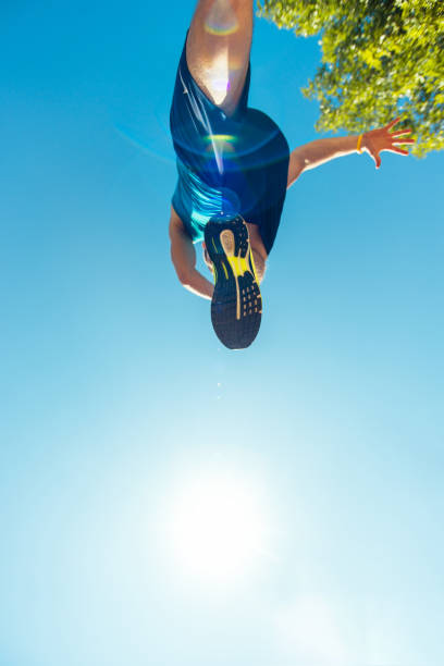 istock Running sneakers from bottom on mans leg 1383430456