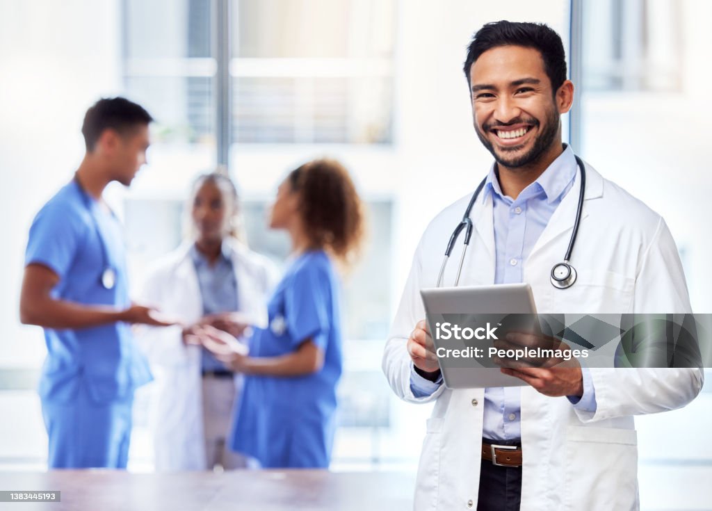 Shot of a young male doctor using a digital tablet at work Helping people back to good health Doctor Stock Photo