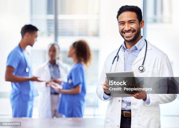 Shot Of A Young Male Doctor Using A Digital Tablet At Work Stock Photo - Download Image Now