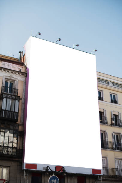 blank poster on a building facade - vertical imagens e fotografias de stock