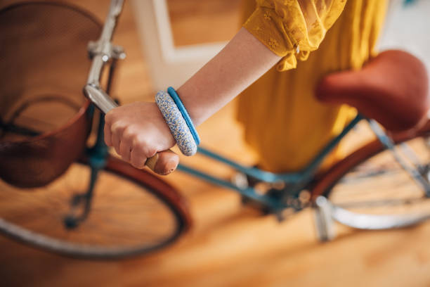 Woman pushing in a bicycle at home.