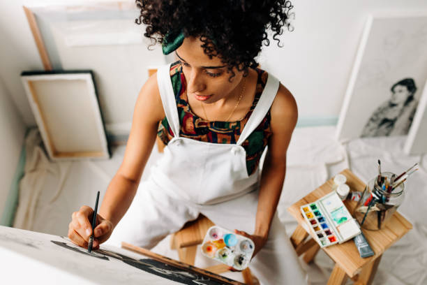 istock High angle view of a female painter working in a workshop 1383460203