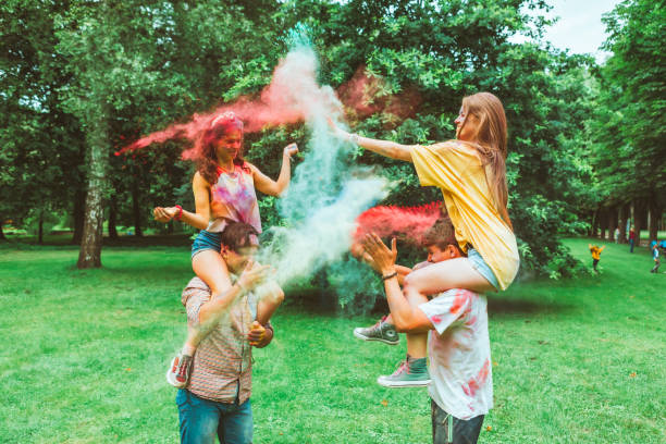 young happy friends at holi fest indian traditional holiday