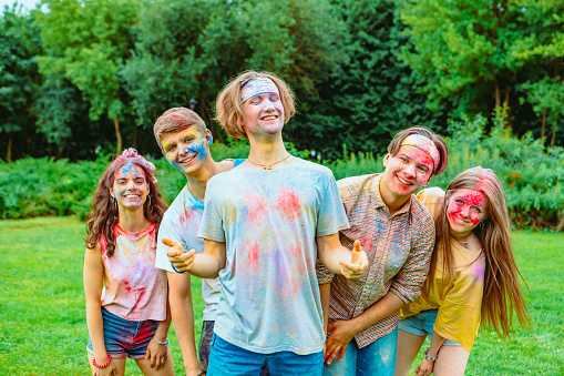 young happy friends at holi fest indian traditional holiday