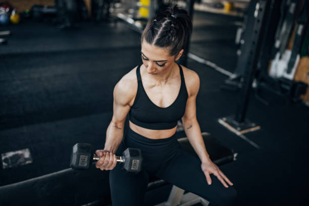istock Woman exercising with dumbbell 1383464045