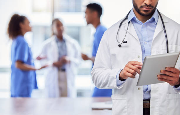 istock Shot of an unrecognizable doctor using a digital tablet at work 1383464308