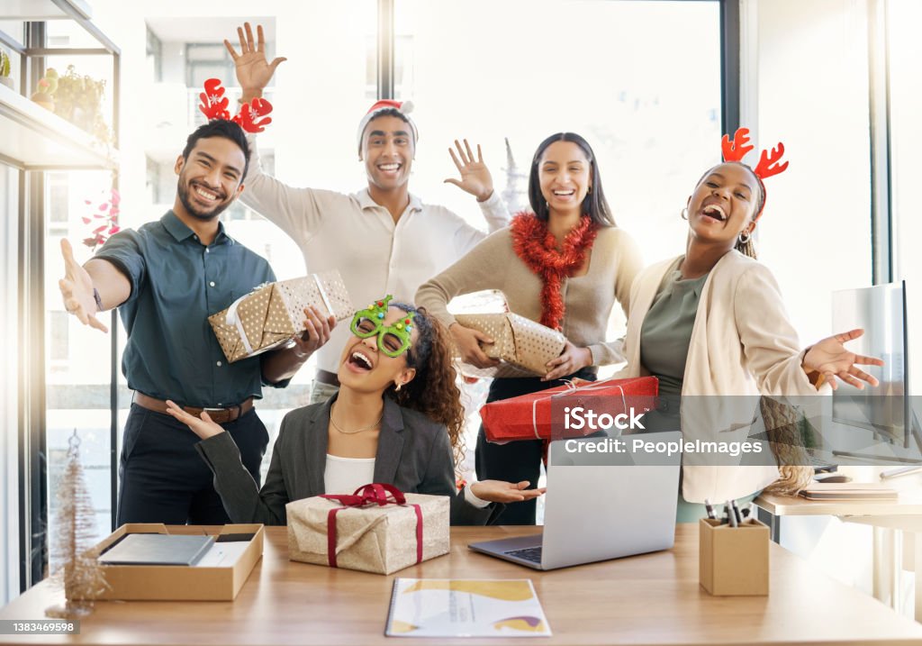 Shot of a group of businesspeople celebrating during a Christmas party at work Sharing the Christmas spirit Christmas Stock Photo