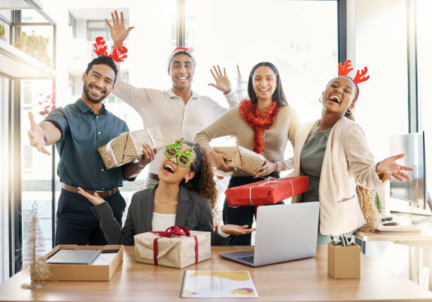 Shot of a group of businesspeople celebrating during a Christmas party at work Sharing the Christmas spirit office christmas party stock pictures, royalty-free photos & images