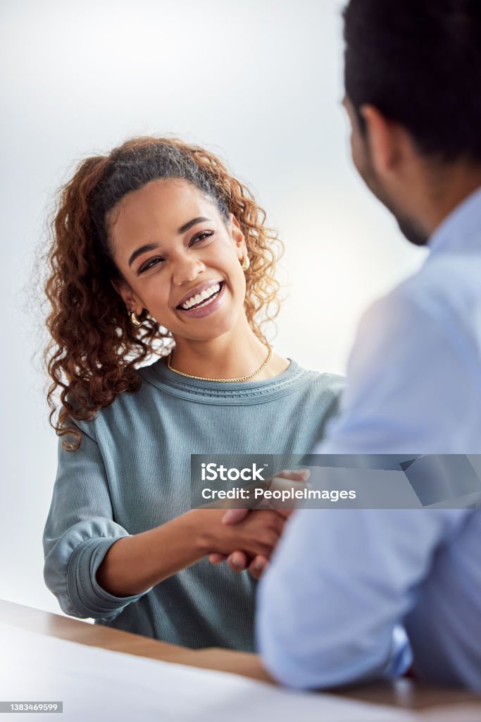 Shot of two businesspeople shaking hands at work Networking is easy for her Human Resources Stock Photo