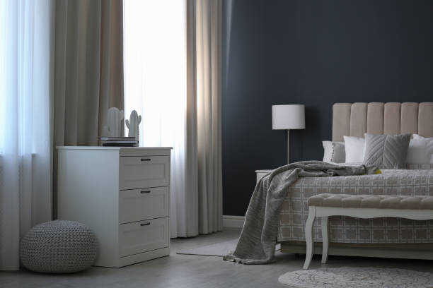 istock Beautiful curtains on window in stylish bedroom interior 1383470489
