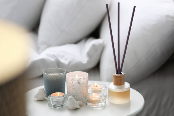 istock Beautiful burning candles on table at home 1383470718