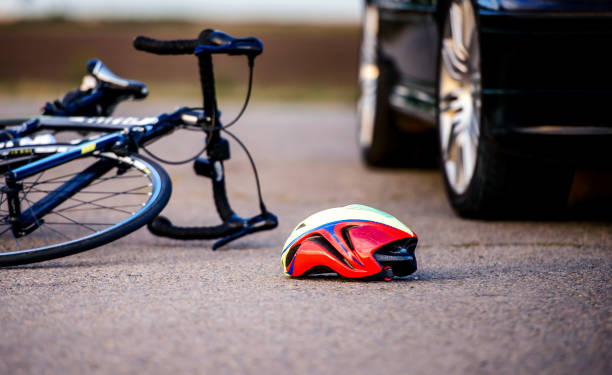 Traffic accident between bicycle and a car Traffic accident. Bicycle and helmet on the road after a car hit a cyclist Distracted stock pictures, royalty-free photos & images