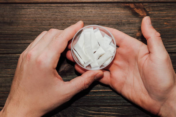 male hands hold in hand a box of snus with nicotine spiders - snuff box imagens e fotografias de stock