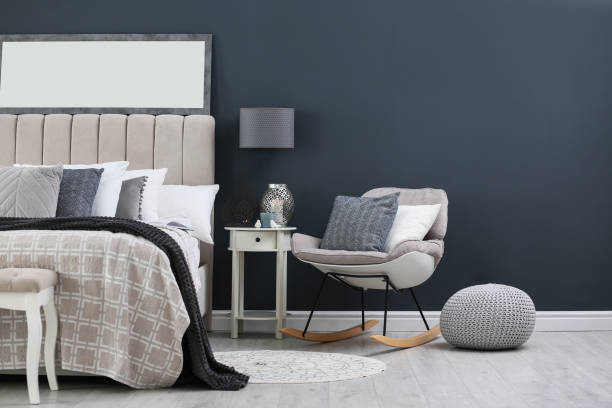 istock Elegant mirror over bed in stylish room interior 1383472330