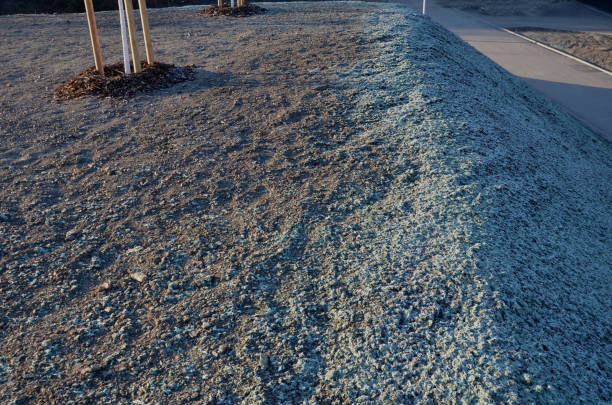 stabilization of slopes by hydro sowing. a mixture of wood pulp and green grass seed is sprayed from the tank directly onto the bare soil. creates a crust and germinating seed, erosion control stabilization of slopes by hydro sowing. a mixture of wood pulp and green grass seed is sprayed from the tank directly onto the bare soil. creates a crust and germinating seed, quality control, cellulose, adhesive binder, bare, detail, soil, stabilize, greenery, hydro seeding, semaphore, pulp erosion control stock pictures, royalty-free photos & images