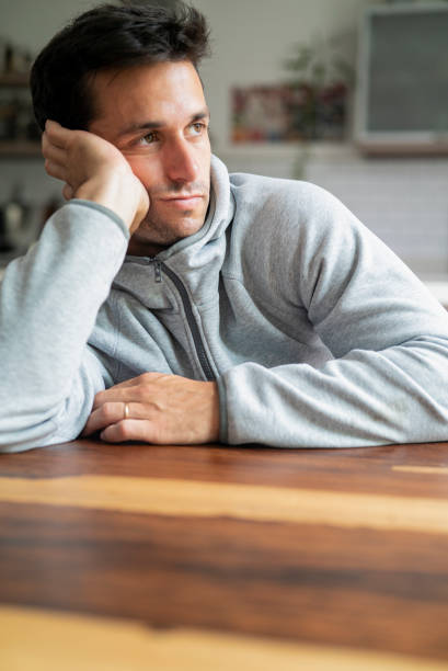 istock Tired young adult hispanic man leaning on hand 1383473972