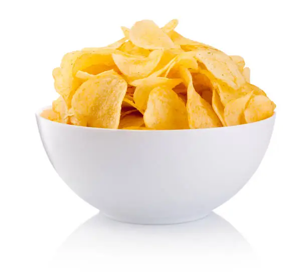 Photo of Potato chips in bowl isolated on white background