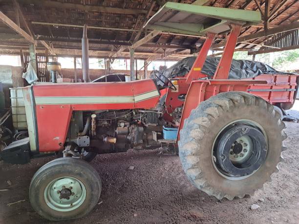 istock Tractor in a shed on a farm. 1383476344