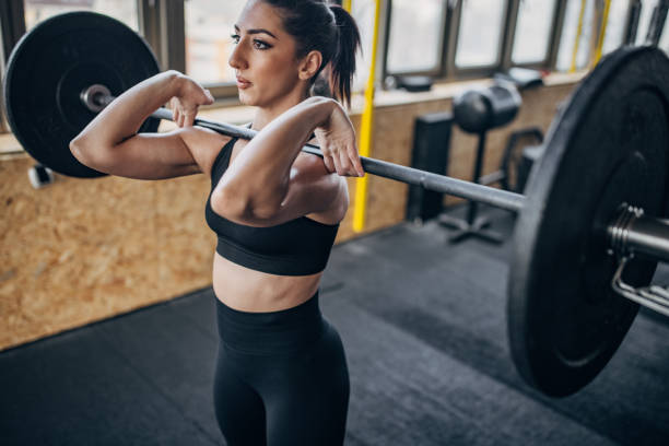 istock Fit woman exercising with weights 1383476396