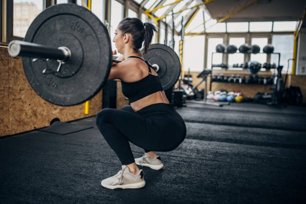 istock Fit woman exercising with weights 1383476594