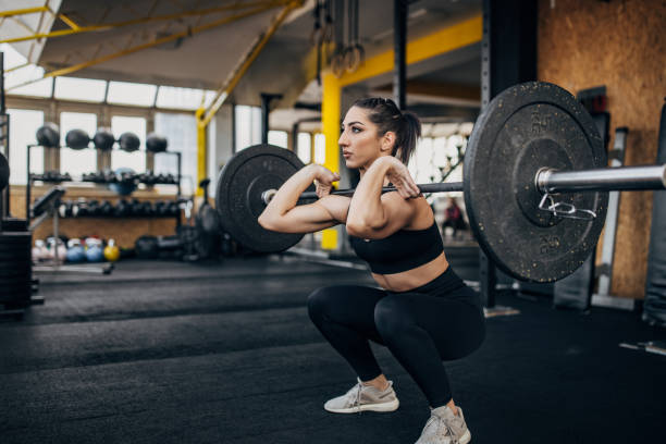istock Fit woman exercising with weights 1383476636