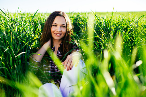 Beautiful young girl lying in a wheat field