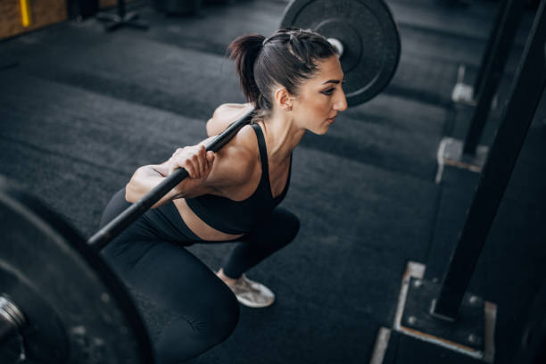 istock Fit woman exercising with weights 1383477076