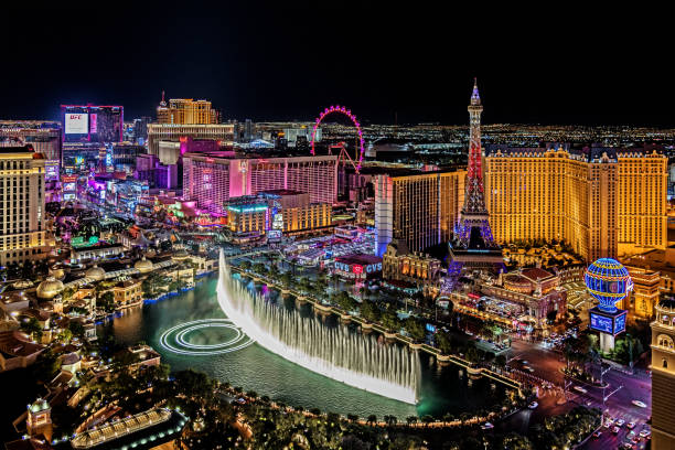 Panoramic view of Las Vegas strip at night in Nevada. Las Vegas, USA - November 27, 2021  The famous Las Vegas Strip with the Bellagio Fountain. The Strip is home to the largest hotels and casinos in the world. las vegas stock pictures, royalty-free photos & images