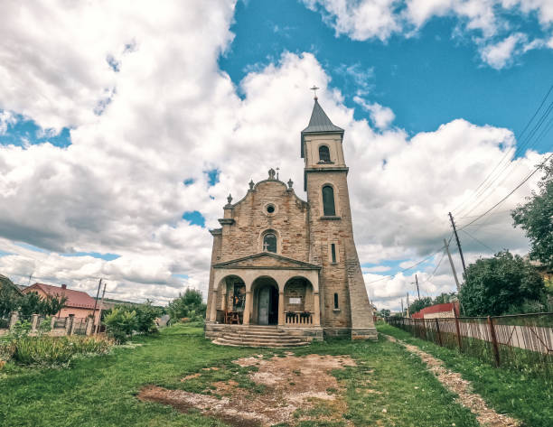 istock Ancient stone church on a background of cloudy sky. 1383478651