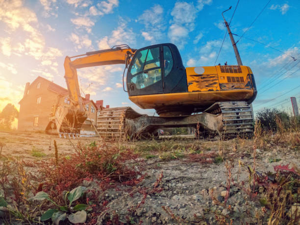 istock Yellow excavator on a construction site. Heavy industry tractor. Blue sky background. 1383478668