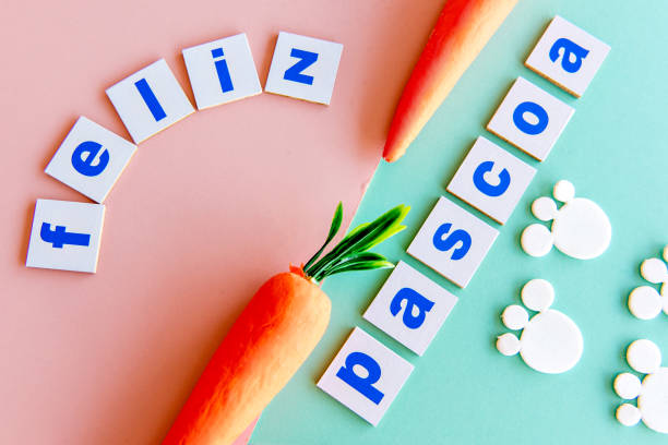 istock Easter concept, easter carrots on green background with (happy easter) written in Portuguese. 1383479333