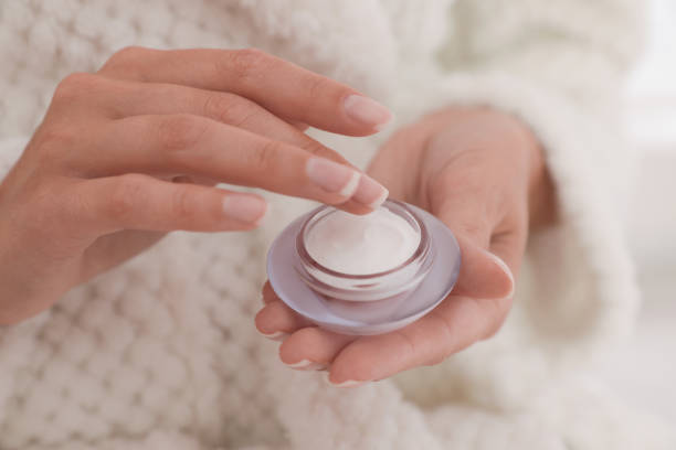 istock Woman holding open jar with cream, closeup 1383481528