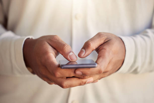 istock Shot of an unrecognizable businessperson using a phone at work 1383481639