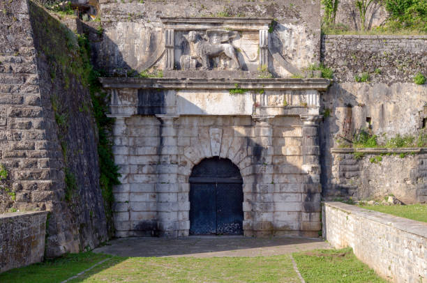 istock Part of an ancient wall with a door 1383484523