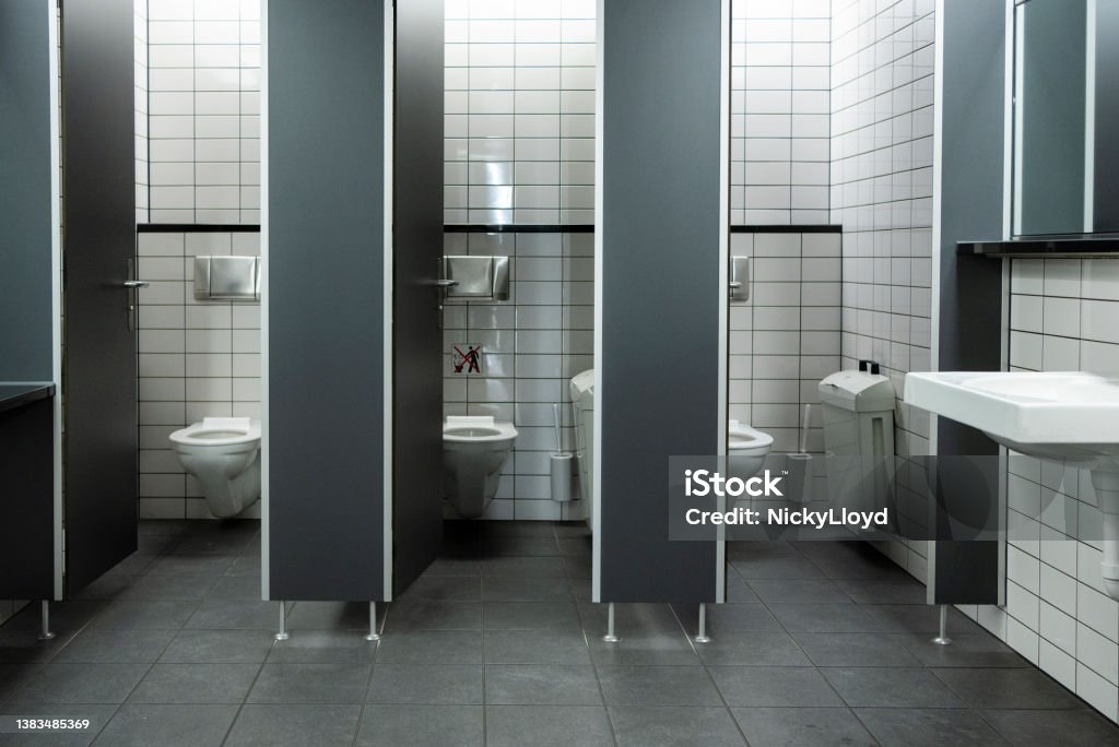 Toilet cubicles with open doors in a public restroom Row of toilet cubicles with open doors in a clean public restroom Public Restroom Stock Photo