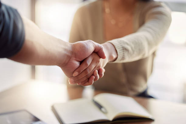 istock Shot of two unrecognizable businesspeople shaking hands at work 1383485383