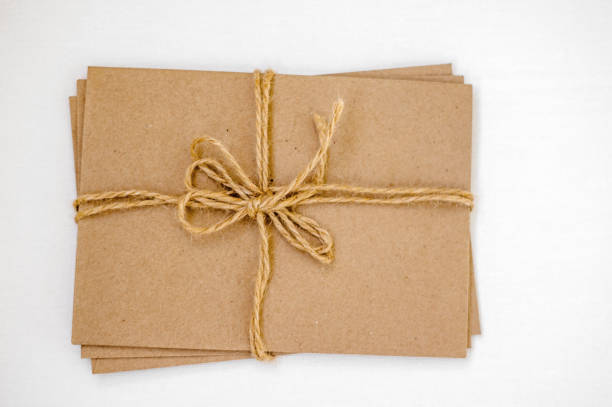 istock Kraft envelopes tied with a gray rope (tow) on a light background. copy space. 1383485470
