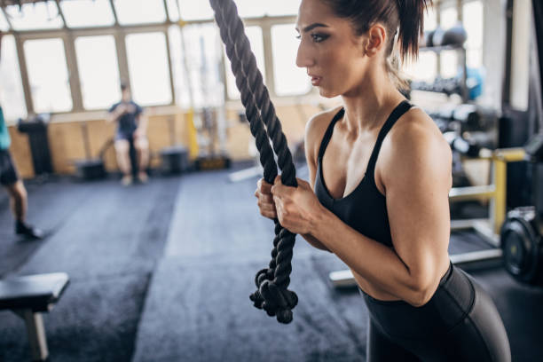 istock Young woman exercising in gym 1383485659