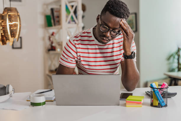 istock Young man having a stressful day while working on a laptop 1383486779