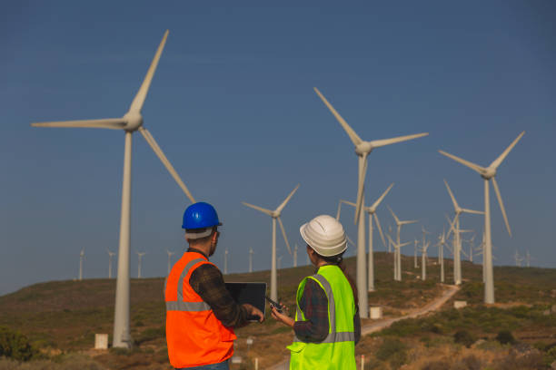istock Young maintenance engineer team working in wind turbine. 1383487196