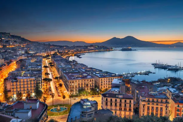 Naples, Italy aerial skyline on the bay with Mt. Vesusvius at dawn.