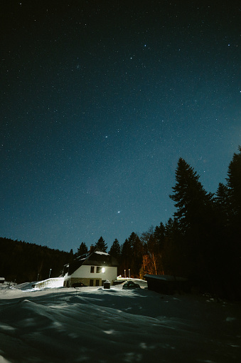 Mountain lodge beneath the night sky.