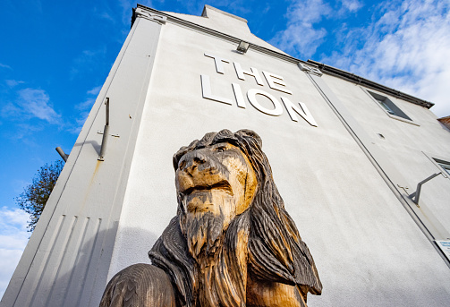 The Lion Hotel of Belper in Derbyshire, England, with a sculpture of a lion outside the hotel